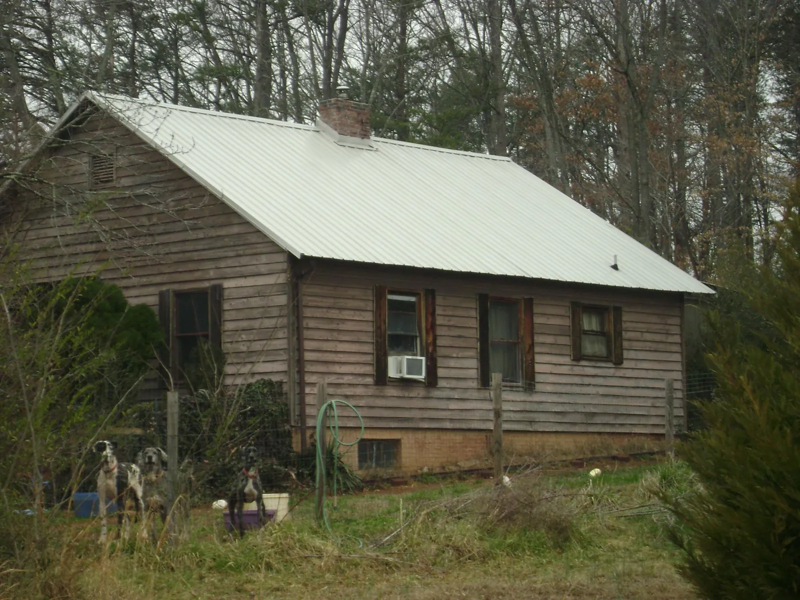 White metal roof on an old wood sided farmhouse, from a Metal Roof Installation job in Mount Ayr
